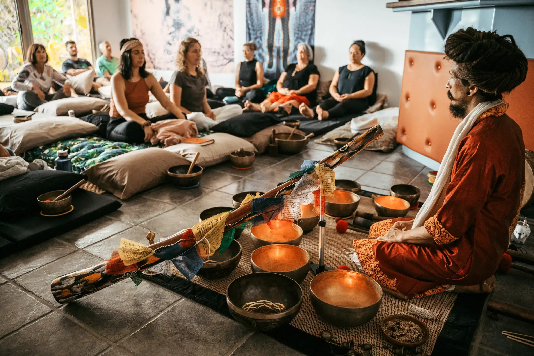 Master Chaitanyashree and a group of people sitting in meditation for a group retreat